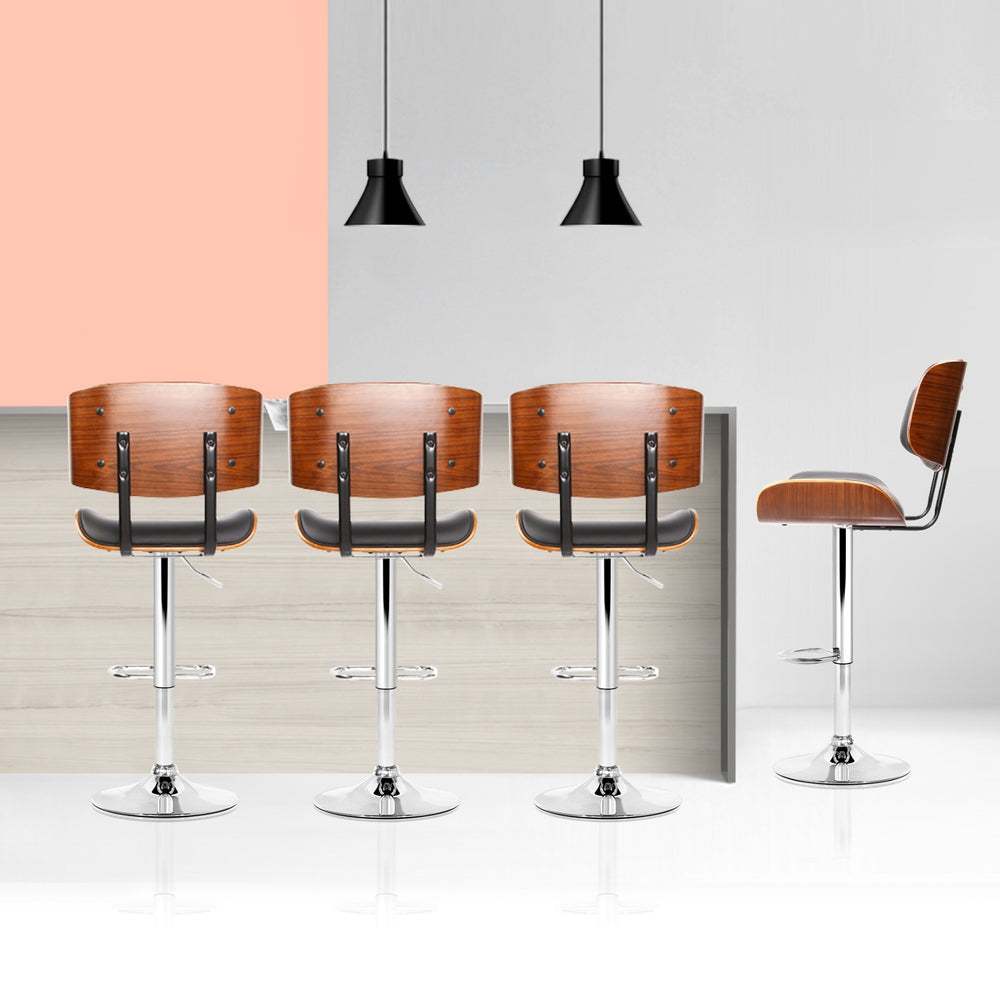Artiss 4x Bar Stools with black PU leather seats and chrome bases in modern kitchen setting.