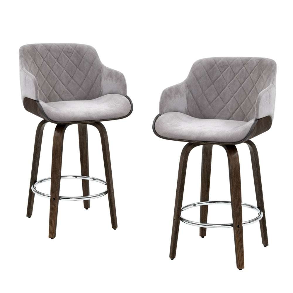 4x grey velvet swivel bar stools with wooden legs and chrome footrest.
