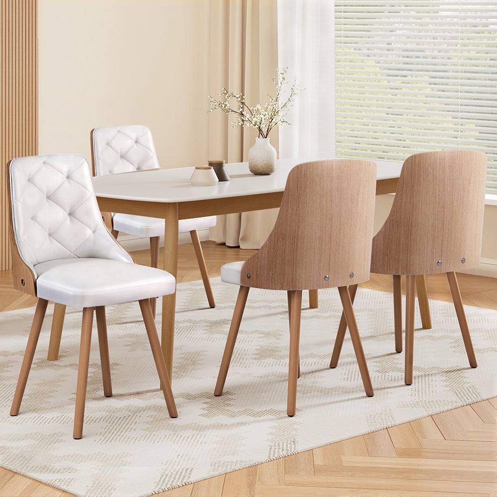 White Artiss Dining Chairs set of 4 with PU leather and wooden legs in dining room.