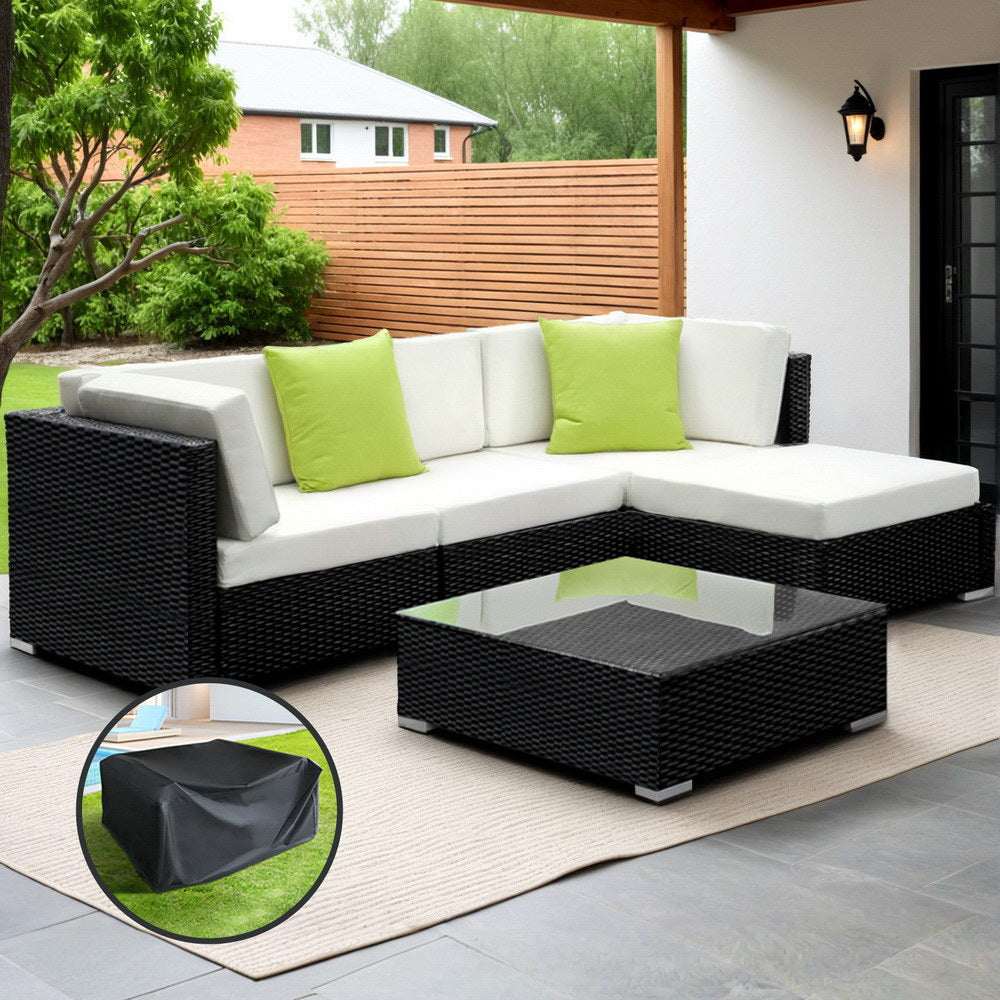 Gardeon 5-Piece Outdoor Sofa Set with black wicker and beige cushions, featuring a tempered glass table and lime green throw pillows, on a patio with a storage cover.