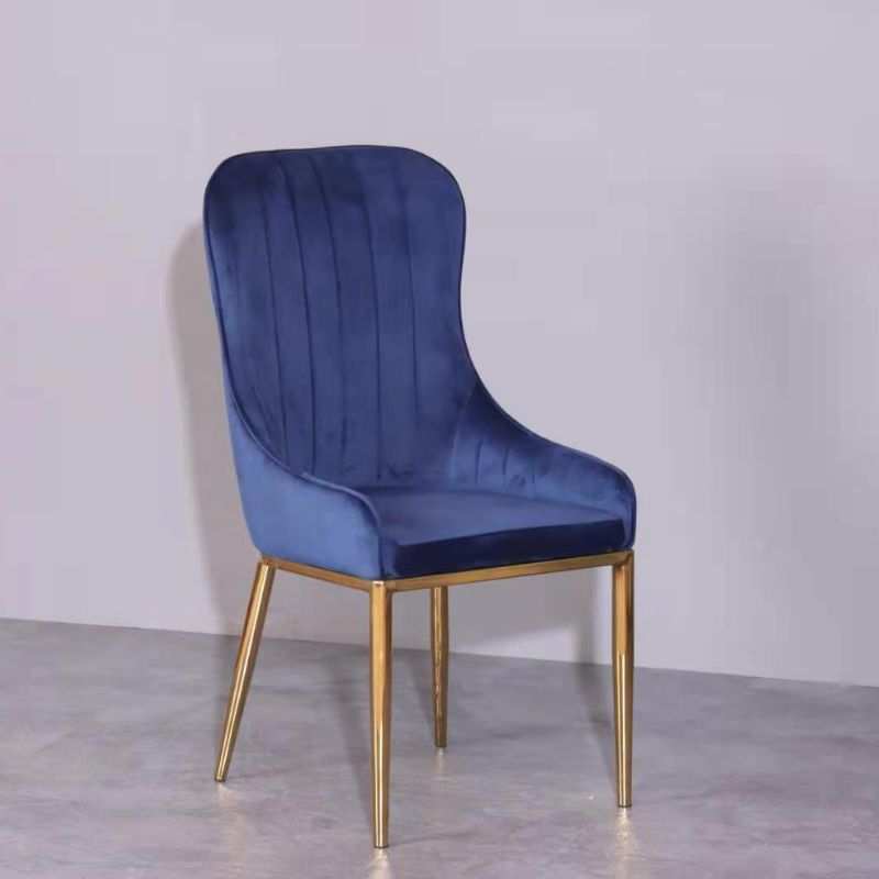 Blue and gold velvet dining chair with metal legs and wooden frame.
