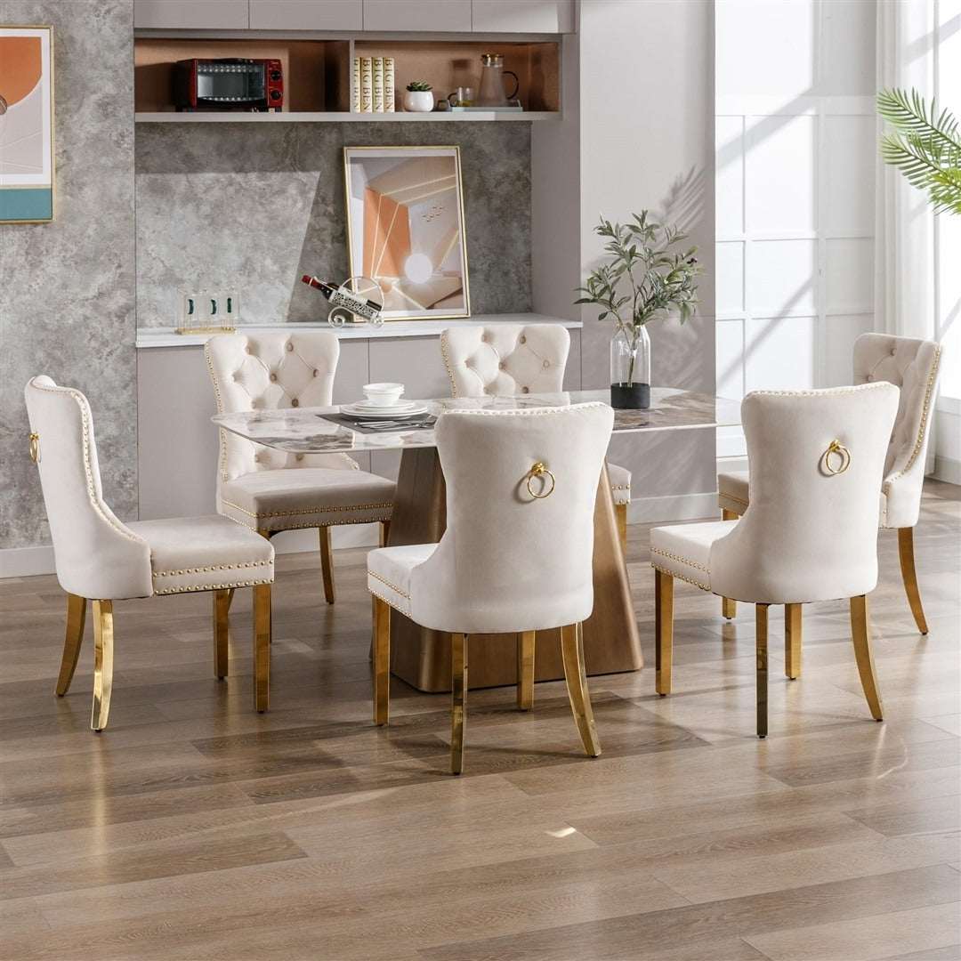 Velvet dining chairs with gold metal legs in a modern kitchen setting.