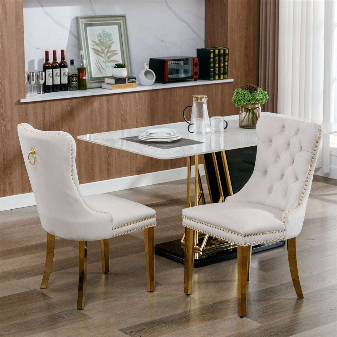 Beige velvet dining chairs with gold metal legs and button-tufted design.