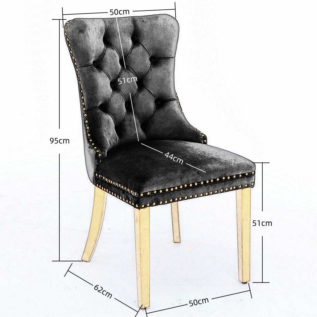 Black velvet dining chair with golden metal legs and button-tufted design.