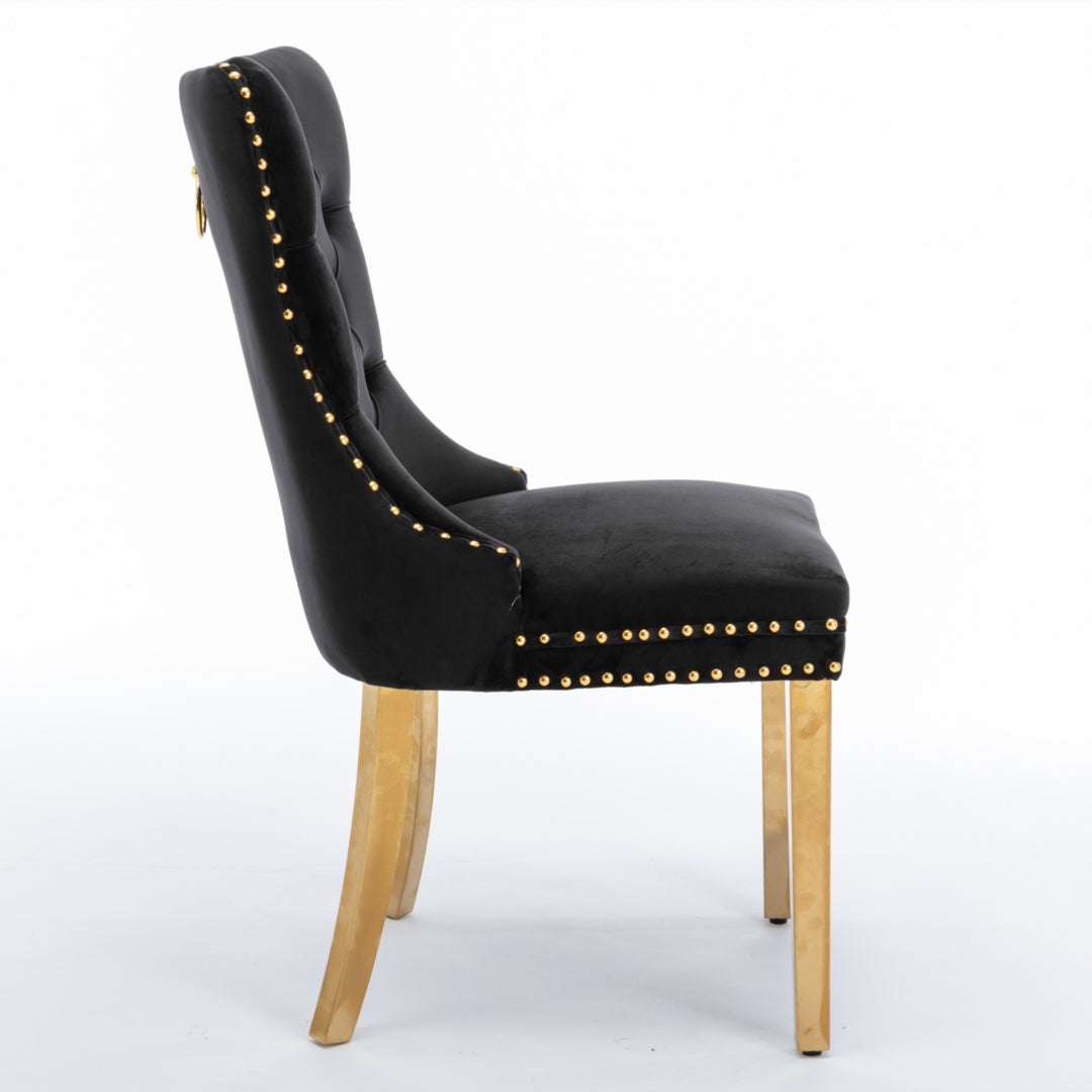Black velvet dining chair with button-tufted back, gold metal legs, and decorative studs.