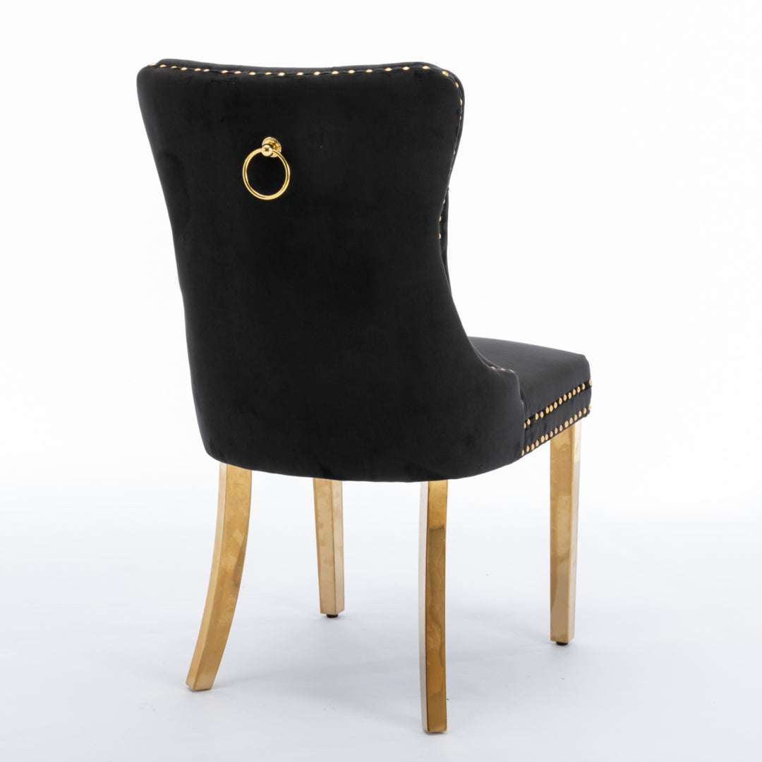 4x black velvet dining chairs with golden metal legs and button-tufted back.
