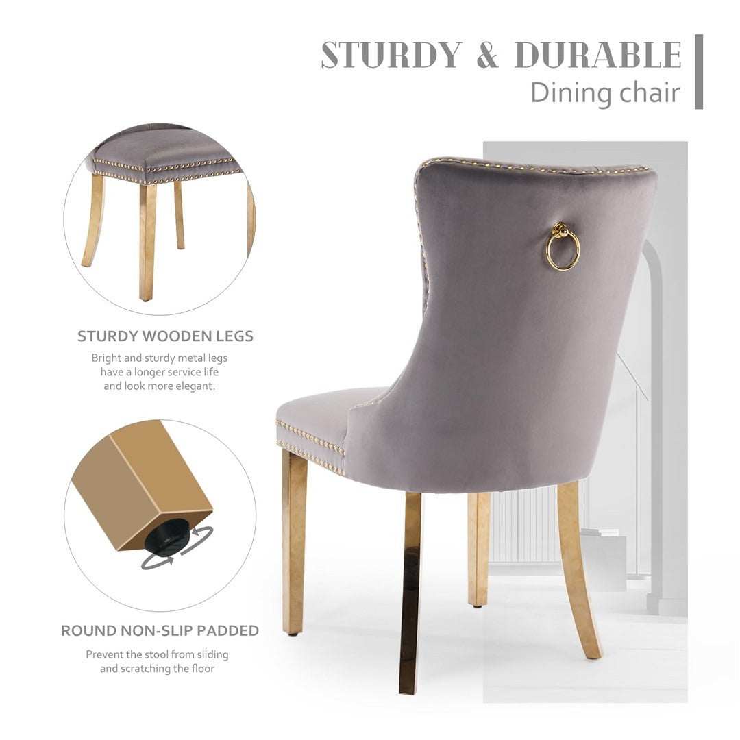 Grey velvet dining chair with gold metal legs, button-tufted backrest, and decorative stud trim for a luxurious dining experience.