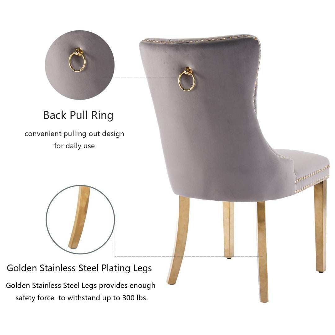 Gray velvet dining chair with curved back, gold metal legs, and decorative pull-out ring.