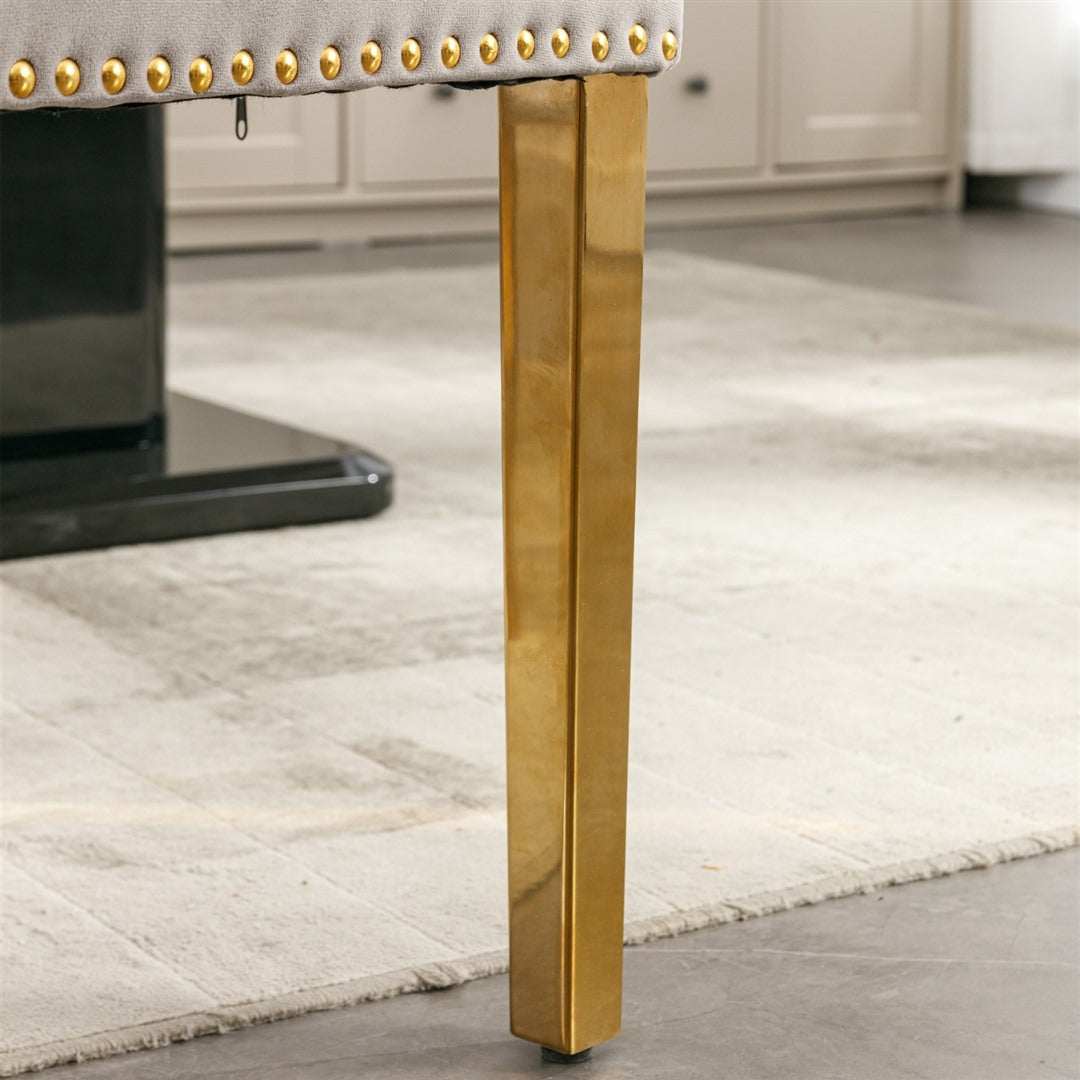 Velvet dining chair with golden metal leg and button-tufted design in grey.