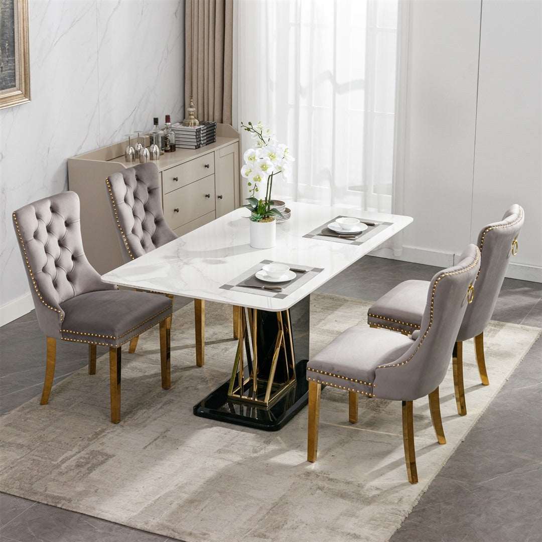 Velvet dining chairs in grey with gold metal legs, tufted backrests, and decorative studs.