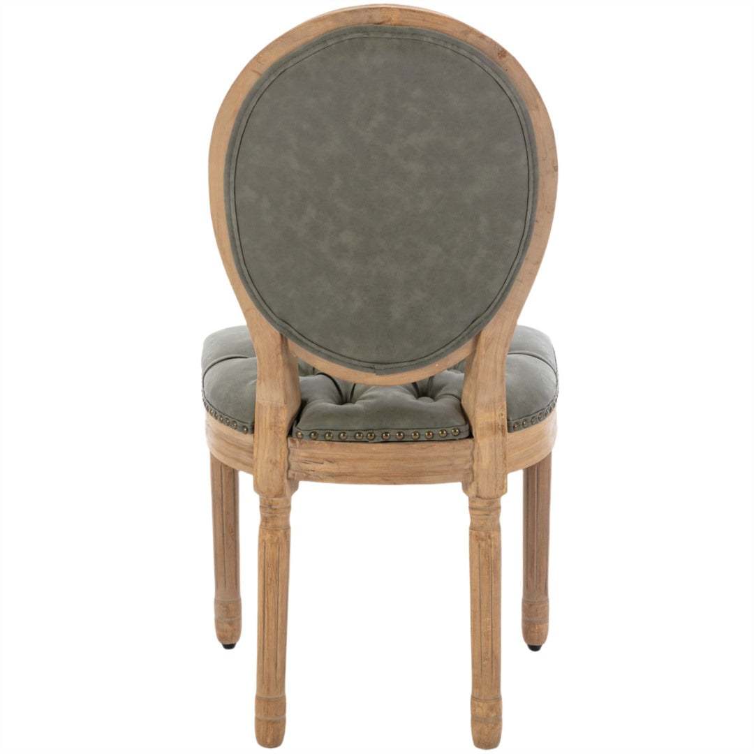 Velvet faux leather dining chair with solid wood legs in pine green color, featuring a hand-tufted back and nailhead trim.