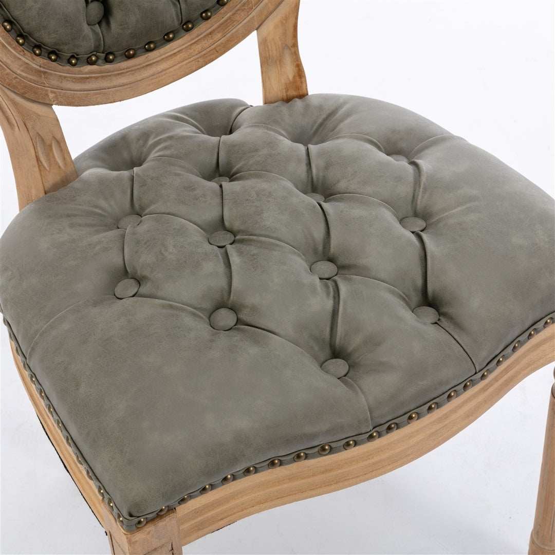 Velvet faux leather dining chairs with solid wood legs in pine green, featuring hand-tufted accents and nailhead trim for a luxurious look.