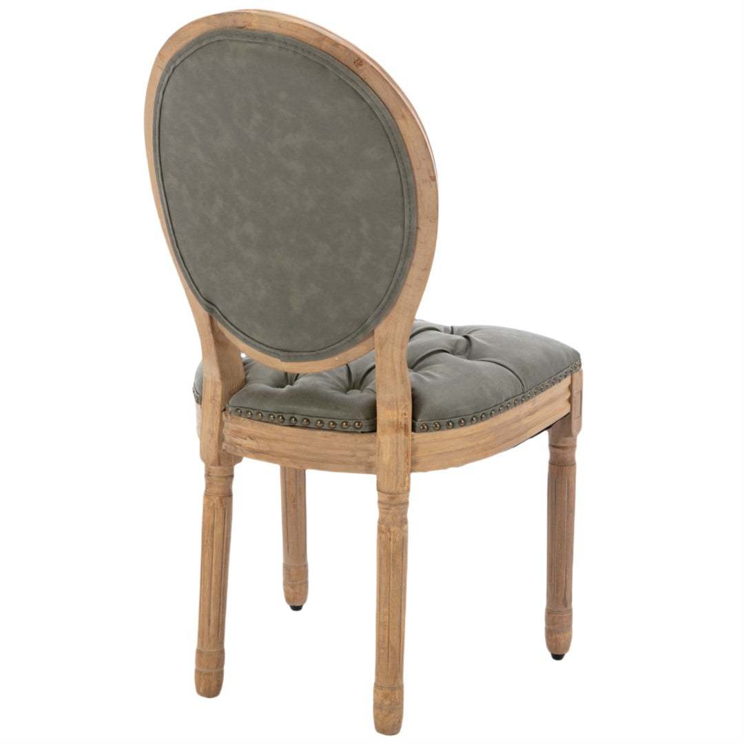 Velvet faux leather dining chair with solid wood legs in pine green, featuring tufted back and nailhead trim.