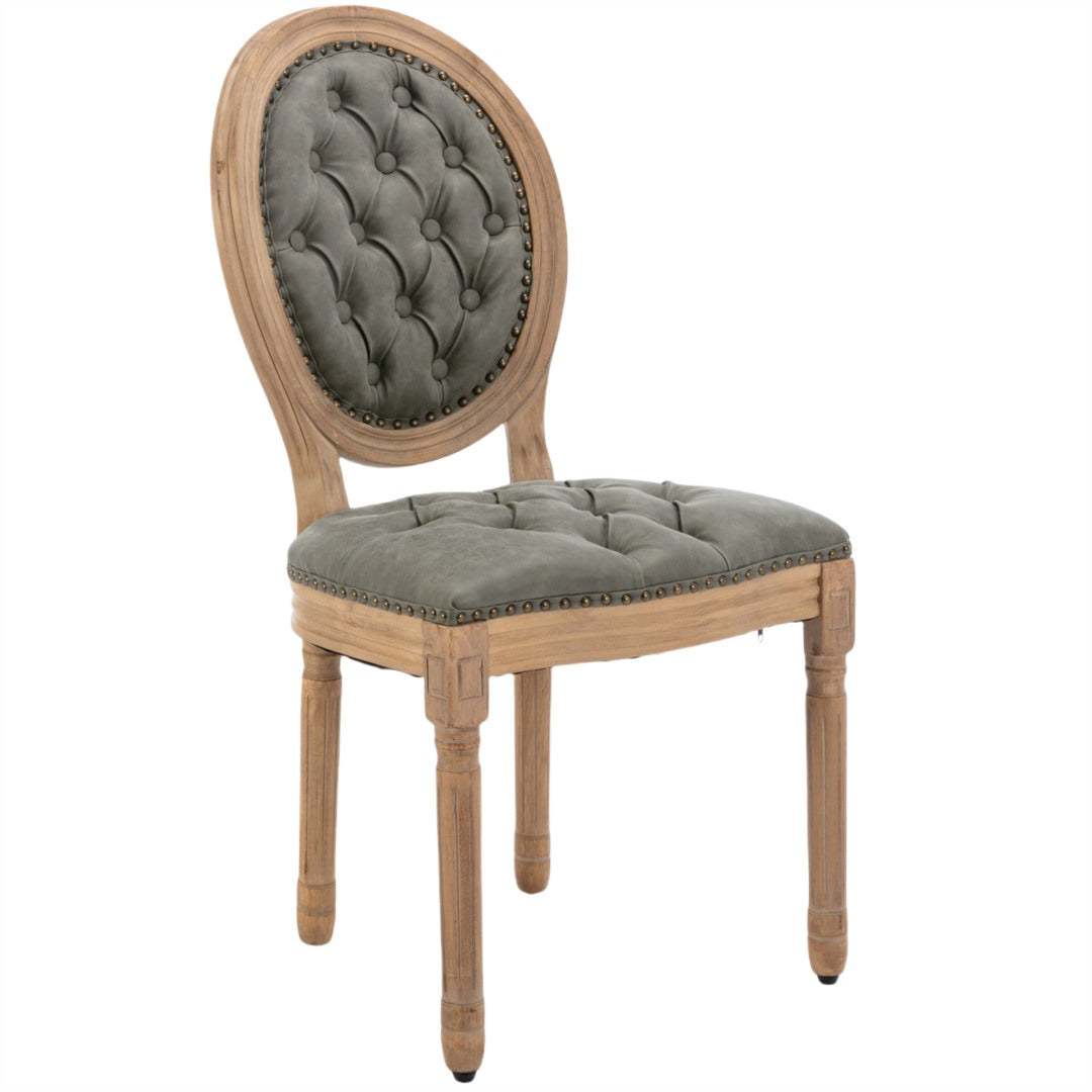 Velvet faux leather dining chair with solid wood legs in pine green, tufted design, and nailhead trim detailing.