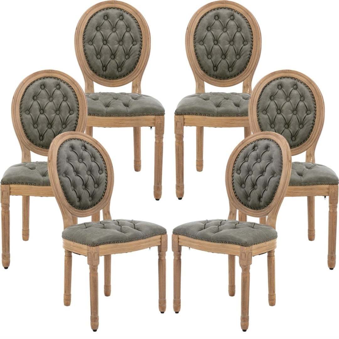 Velvet faux leather dining chairs with solid wood legs in pine green, featuring hand-tufted detailing and nailhead trim.