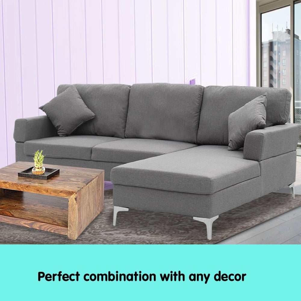 Dark grey Sarantino 3 seater linen sofa with left side chaise and chrome-painted legs in a modern living room.