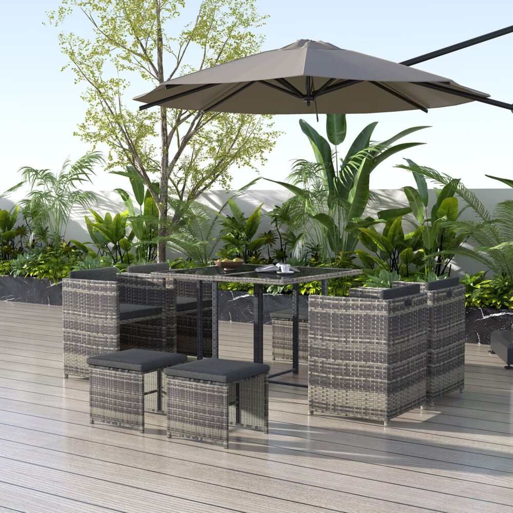 Horrocks 8 Seater outdoor dining set in grey rattan with a rectangular table, armchairs, and ottomans on a patio.