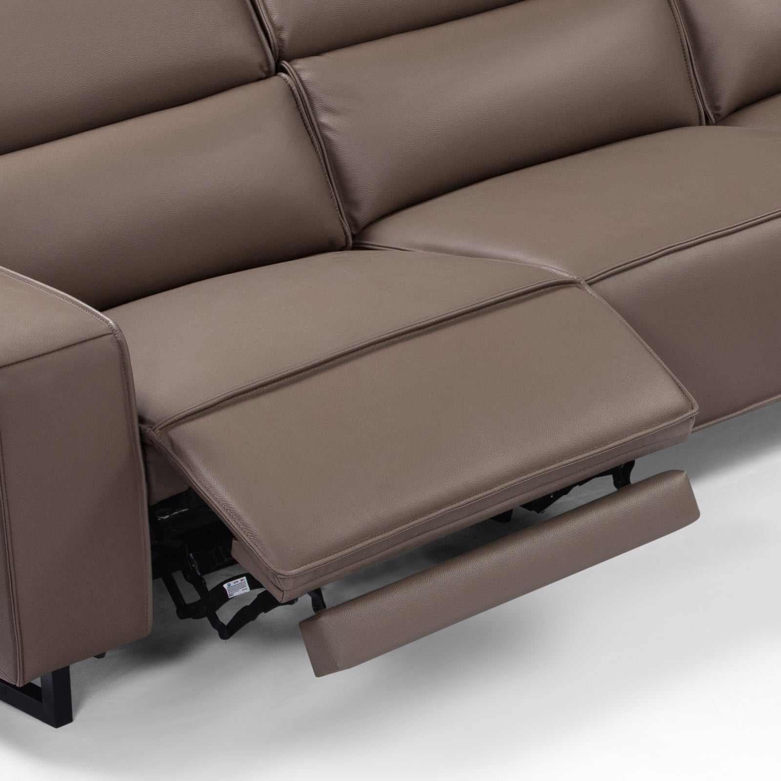 5 seater real cow leather sofa with power recliner and adjustable headrest in a corner lounge setting.