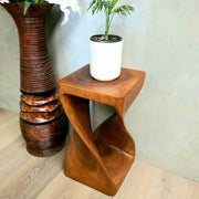 Twist Raintree Wood side table with twisted design, handcrafted from solid wood, ideal as corner or lamp table.