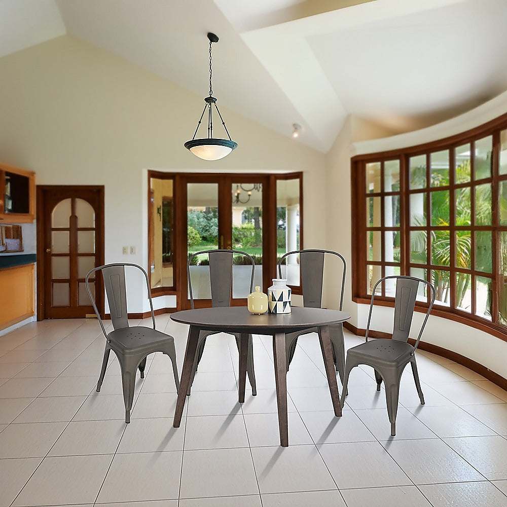 Stackable vintage metal kitchen dining chairs with backrest, set of four, in a modern dining room setting.