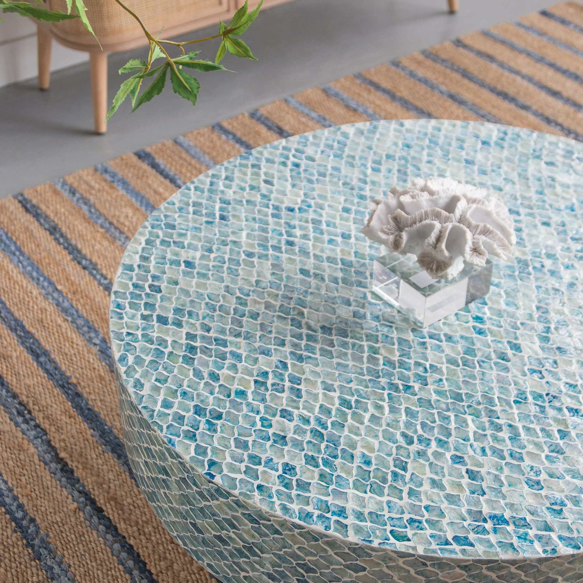 GOA SHELL COFFEE TABLE with blue hued shell pieces and white background.