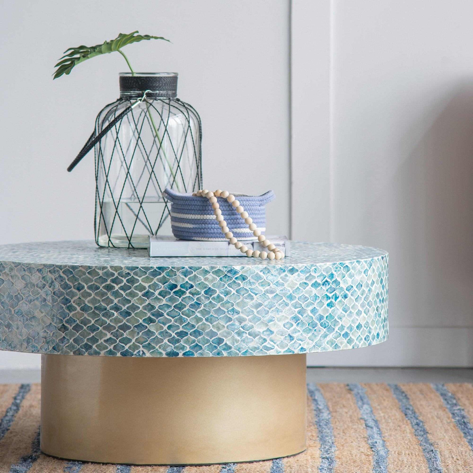 GOA SHELL COFFEE TABLE with blue shell pieces and white background.