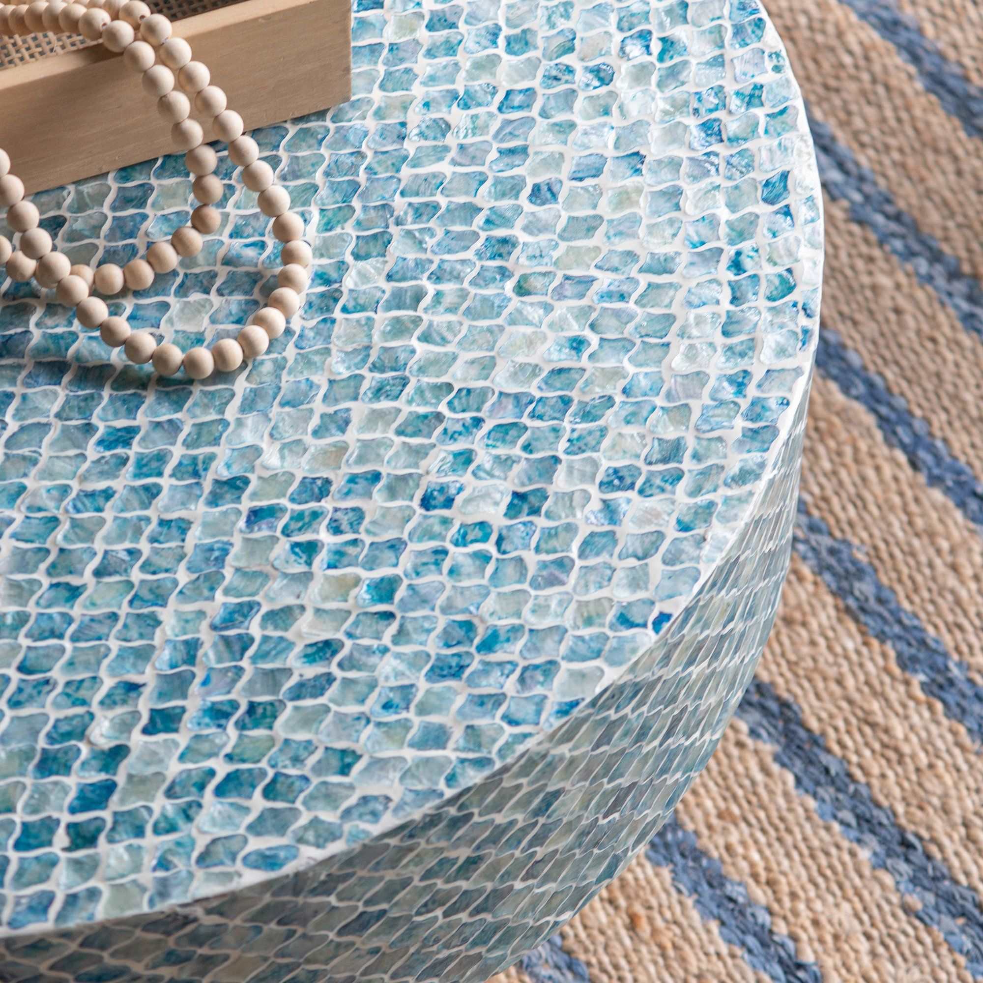 GOA SHELL COFFEE TABLE with blue-hued shell pieces and white background.